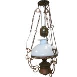 A rise & fall brass & copper oil lamp, with weighted mechanism on three chains suspended from