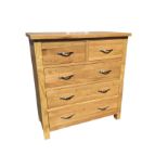 A contemporary oak chest of drawers with two short and three long drawers mounted with plated