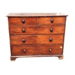 A Victorian pine chest of drawers with two short and three long knobbed drawers, raised on bracket