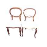 Two Victorian baloonback mahogany dining chairs with stuffover upholstered seats, raised on cabriole