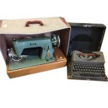 A boxed cast iron enamelled Alfa sewing machine on wood base; and a cased portable Imperial Good