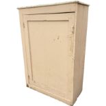 A plain painted Victorian cupboard with panelled door enclosing shelves, raised on plinth. (39.5in x