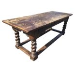 An eighteenth century oak refectory table with rectangular two-board top having cleated ends,