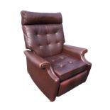 A Parker Knoll reclining armchair with button upholstery and loose cushion, above a sprung seat,