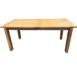 A rectangular limed oak drawer-leaf kitchen table, the cleated top on rectangular legs with leaf. (