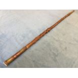 A tapering blackthorn cane having brass terminal, with copper & brass wired decoration to handle,