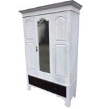 A painted late Victorian wardrobe with moulded cornice above an arched bevelled mirror door