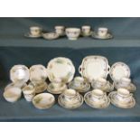 A Royal Stafford 12-piece part teaset decorated with garlands and floral medallions; and a Clare