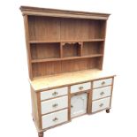 A nineteenth century pine dresser, the delft rack with moulded cornice above open shelves with