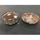 A circular silver ladies dressing table pot with hinged lid, raised on paw feet; and a scalloped