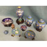 A collection of cloisonné on stands - a pair of ginger jars & covers, vases, bowls, a pair of