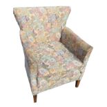 A floral tapestry upholstered armchair with spade shaped padded back above a loose cushion and