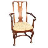 A Queen Anne style mahogany armchair with vase shaped splat and shaped crook arms above a rounded