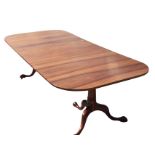 An 8ft reproduction Georgian style walnut dining table by Brights of Nettlebed, the rectangular