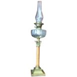 A Victorian brass oil lamp with Duplex twin-wick and tapering chimney above a cut glass bun shaped