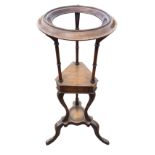 A Georgian style mahogany shaving stand with circular moulded ring for bowl on ring-turned supports,