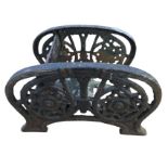 A Victorian cast iron bootscraper with two arched pierced panels having twin floral roundels framing