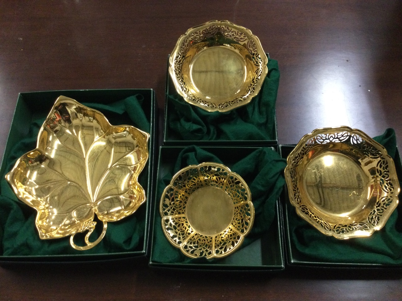 A pair of unused boxed WMF gilt metal dishes with pierced scalloped rims; another of leaf shape with