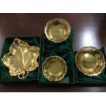 A pair of unused boxed WMF gilt metal dishes with pierced scalloped rims; another of leaf shape with
