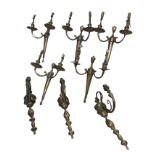 A set of five Edwardian brass wall lights, each with tapering torch shaped column wallplates mounted