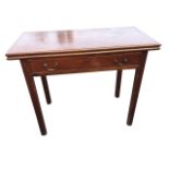 A nineteenth century mahogany turn-over-top tea table, the twin leaves with moulded edge above a