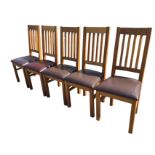 A set of six oak dining chairs with slatted backs above leather cushion seats, raised on square
