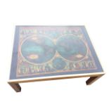 A contemporary glass topped coffee table in brass frame, the top depicting C17th globe maps of the