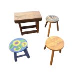 Three circular seated stools - one painted with sunflowers; and a rectangular kracket stool having