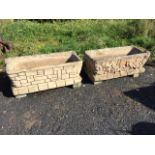 A pair of rectangular composition stone planters with cushion moulded rims above faux brick bodies