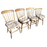A pair of Victorian beech spindleback chairs, the shaped solid seats raised on turned legs and
