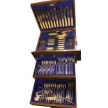 An oak cased canteen of silver plated cutlery, the Walker & Hall cabinet with two drawers containing