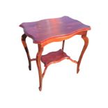 A rectangular Edwardian oak occasional table, the scalloped top on tapering sabre legs joined by