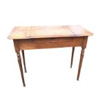 An Edwardian oak dressing table, the rectangular cleated top having opening central compartment with