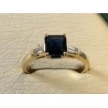 A contemporary square sapphire and diamond ring set on an 18ct gold band, the claw set stone of 1.