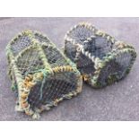 A pair of 2ft lobster pots with arched frames on rectangular grid bases, having hinged ends, each