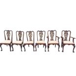 A set of six Chippendale style mahogany dining chairs with scrolled carved backs above interlaced