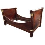 A French nineteenth century mahogany Empire bed with ormolu mounts, the panelled headboard &