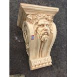 A large plastercast corbel, the scroll bracket with bearded head above a greek key frieze,