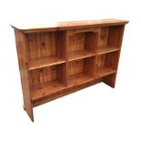 A rectangular pine open shelf unit with moulded cornice above four compartments, having tongue &