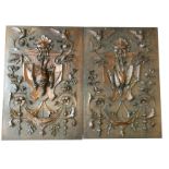 A pair of nineteenth century carved mahogany panels depicting hung game on shields beneath green man