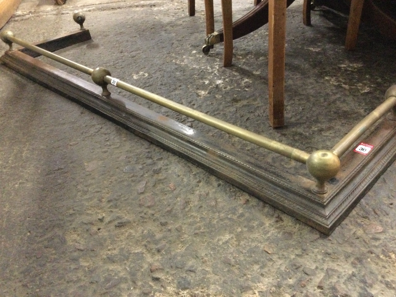 A Victorian brass & cast iron fender with tubular rail on ball mounts above a moulded gadroon cast - Image 2 of 3