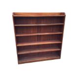 A large plain mahogany open bookcase, with shaped gallery to top above six adjustable shelves,