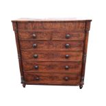 A Victorian mahogany chest of drawers with crossbanded top above two short and four long knobbed