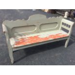 A painted bench seat with shaped back above twin rounded panels, the cushion moulded arms on