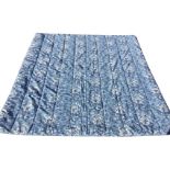 A large blue and white padded Ralph Lauren quilt printed with flowers on blue ground. (queen size