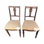 A pair of late Victorian side chairs, the backs with scrolled carvings and pierced splats framed