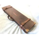 A rectangular leather gun case by Cogswell & Harrison Ltd, the box with brass mounts and lock,