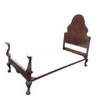 A late Victorian mahogany Queen Anne style single bed, the scalloped arched headboard with foliate