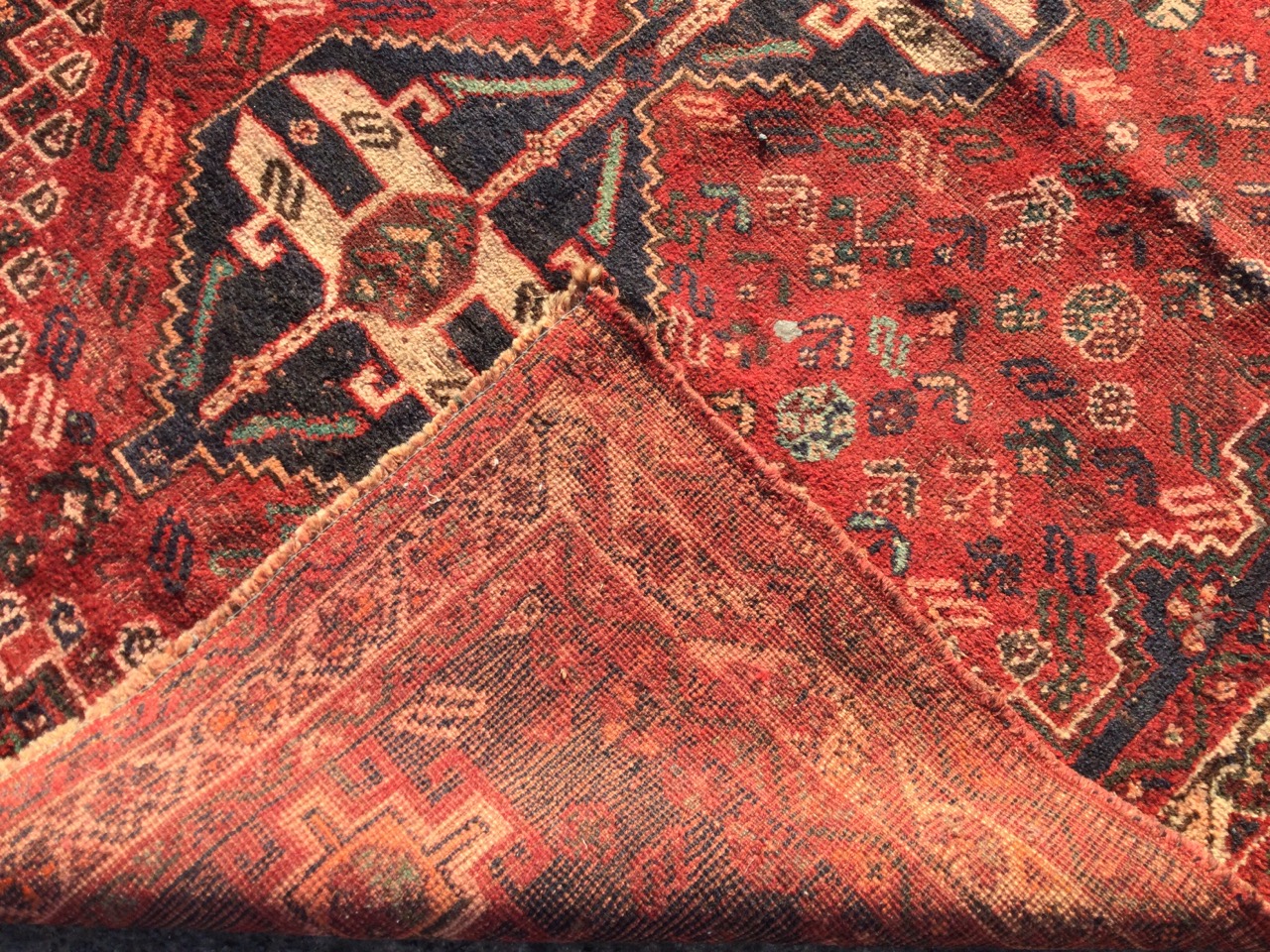 An oriental bokarra rug woven with three linked serrated blue medallions on red field with floral - Image 3 of 3