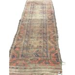 An antique bokarra runner woven with blue framed field within a madder border of hooked waved bands,